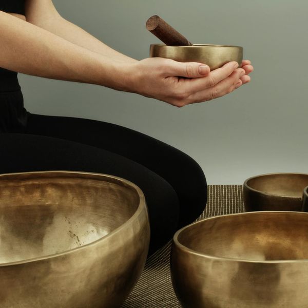 Person sitting in a calm meditation pose with a coral color scheme.